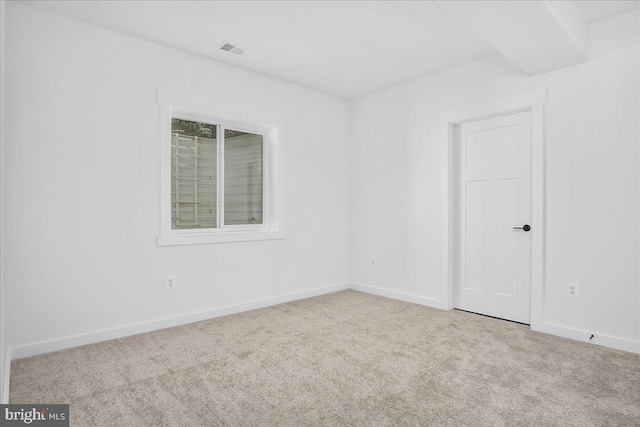 unfurnished room with light colored carpet