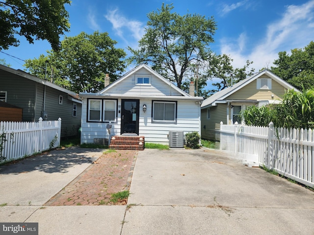 bungalow-style house featuring central AC unit