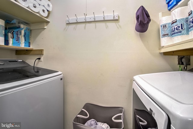 clothes washing area with washer and dryer