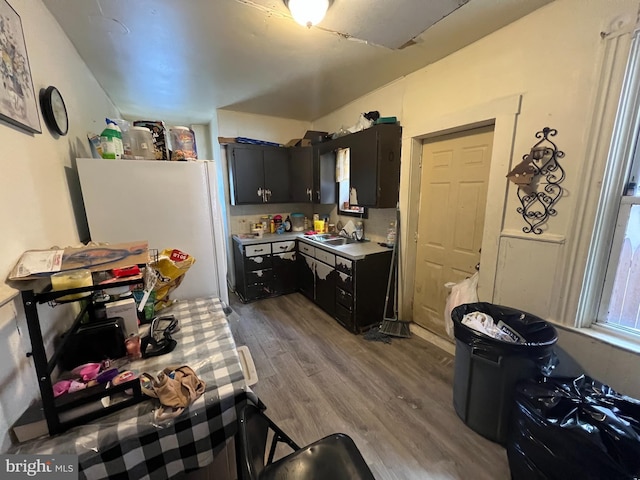 kitchen featuring sink, white refrigerator, and light wood-type flooring