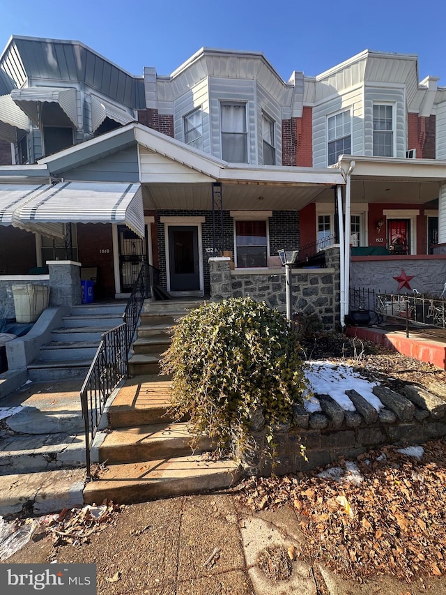 townhome / multi-family property featuring a porch