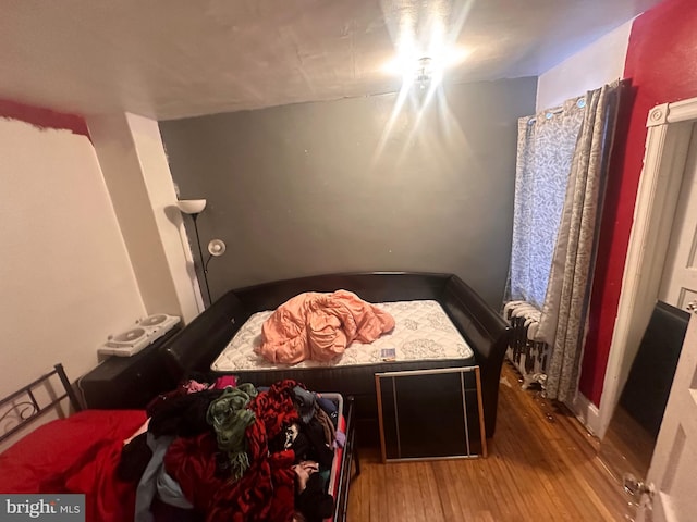 bedroom with hardwood / wood-style flooring