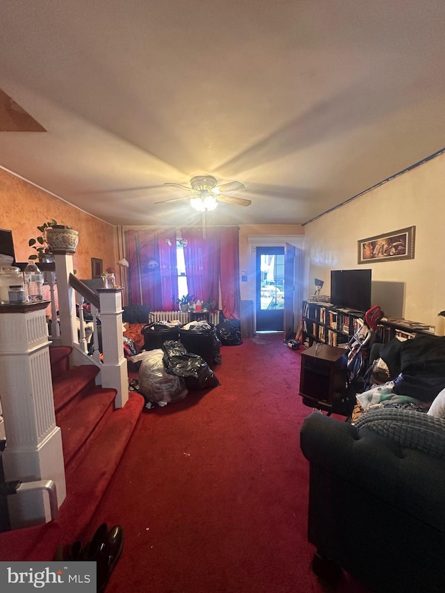 living room featuring ceiling fan and carpet