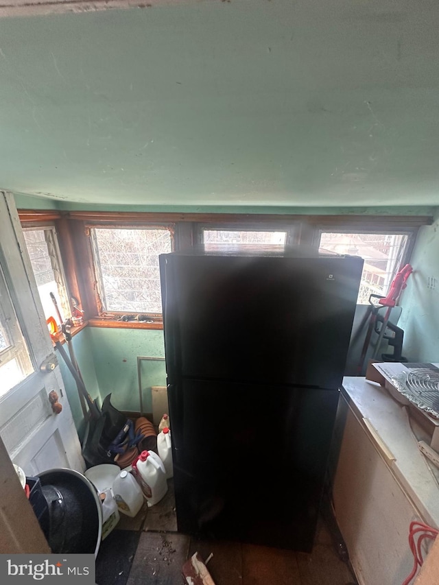 kitchen with a wealth of natural light and black fridge