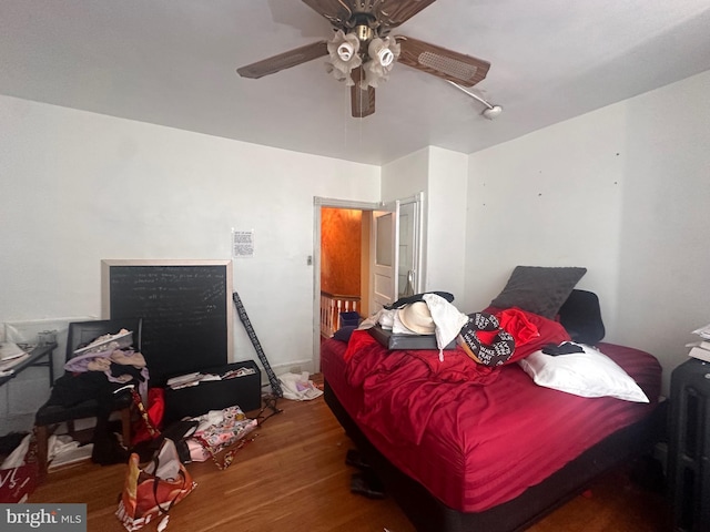 bedroom with ceiling fan and hardwood / wood-style flooring