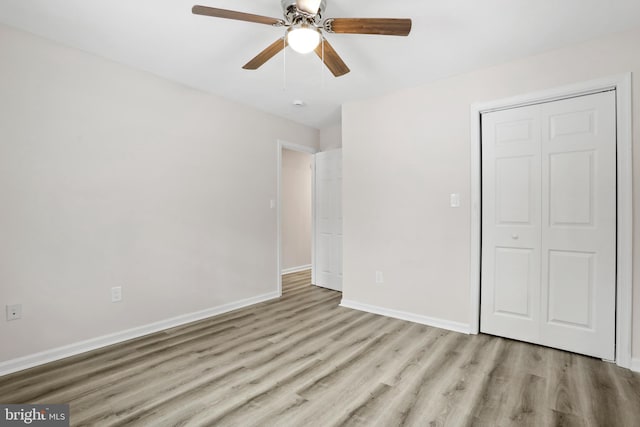 unfurnished bedroom featuring a closet, ceiling fan, and light wood-type flooring