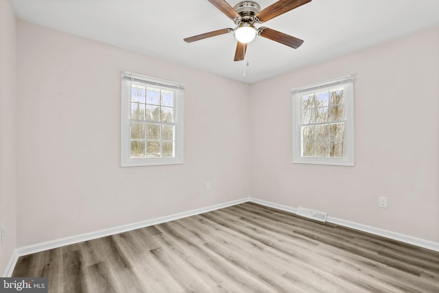 empty room with light hardwood / wood-style floors and ceiling fan