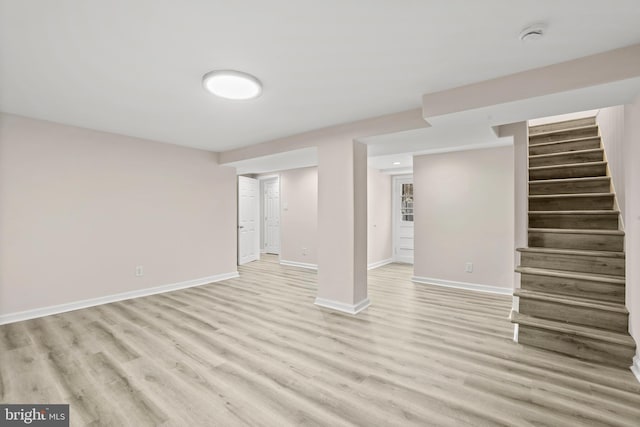 basement with light hardwood / wood-style floors