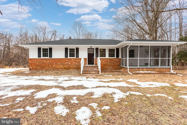 view of front of house featuring a sunroom