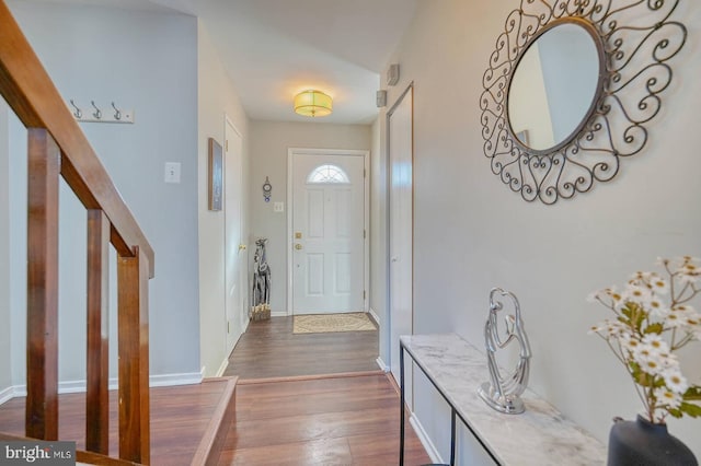 foyer entrance with dark hardwood / wood-style floors