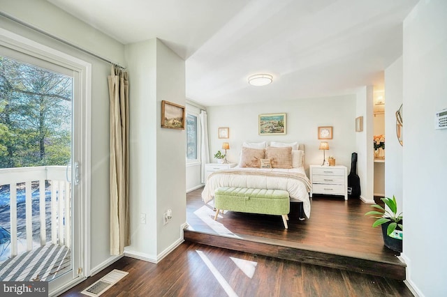 bedroom featuring dark hardwood / wood-style floors and access to outside