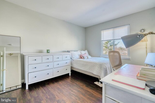 bedroom with dark wood-type flooring