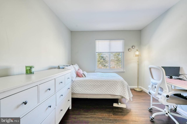 bedroom with dark wood-type flooring