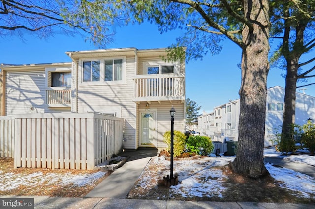 snow covered property with a balcony