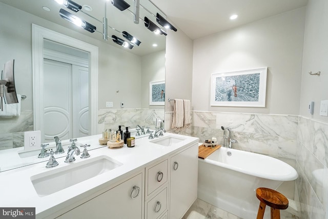 bathroom featuring vanity, a bathing tub, and tile walls