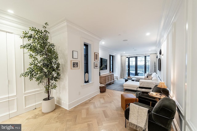 living room with ornamental molding and light parquet floors