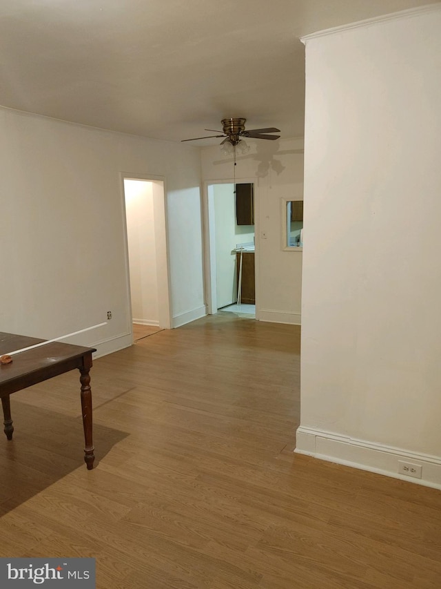 unfurnished room with ceiling fan and wood-type flooring