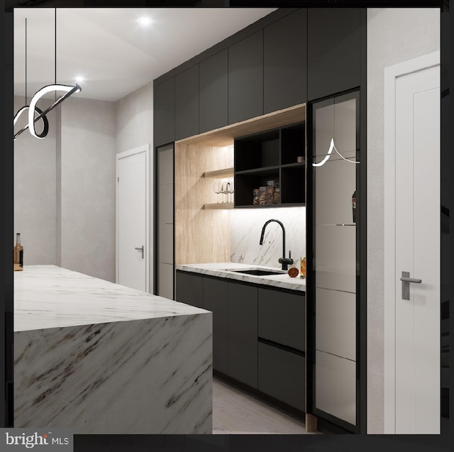 kitchen featuring decorative light fixtures and sink