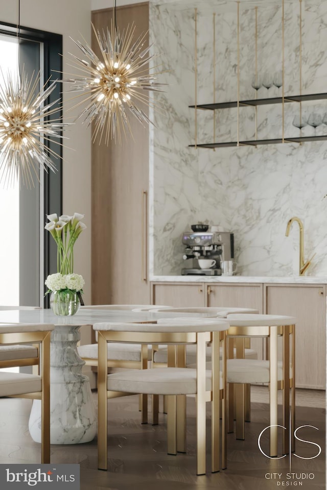 unfurnished dining area featuring sink and a notable chandelier