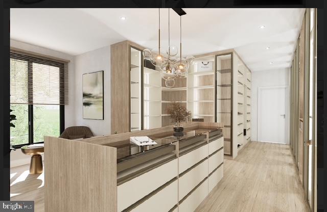 interior space with light hardwood / wood-style flooring and an inviting chandelier