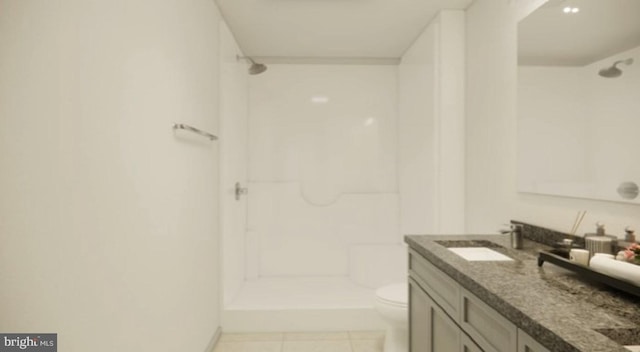 bathroom with vanity, a shower, and toilet