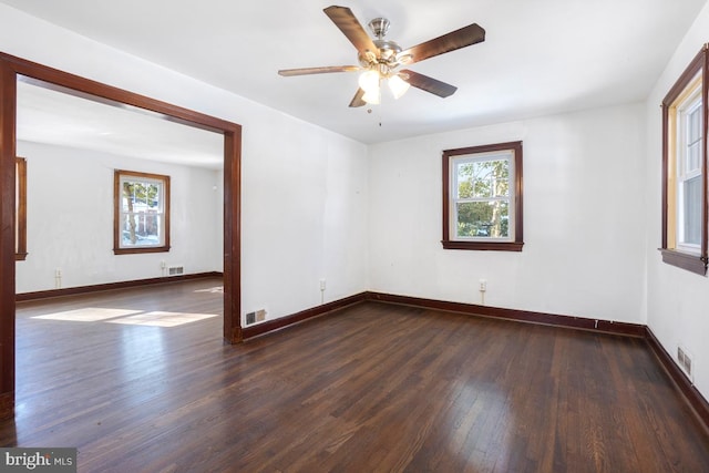 spare room featuring ceiling fan and dark hardwood / wood-style floors