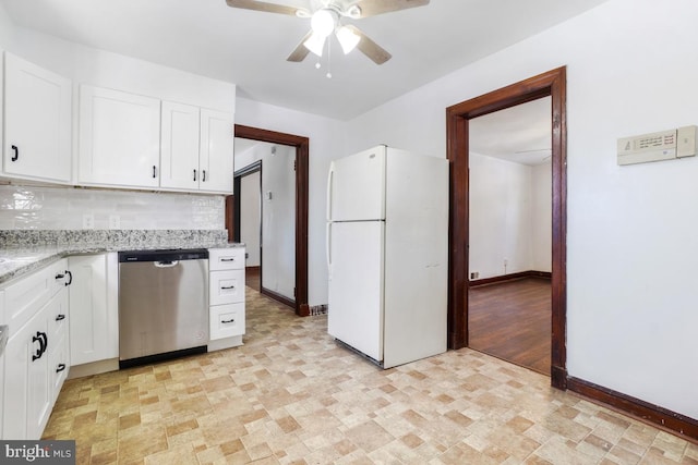 kitchen with light stone countertops, white cabinets, dishwasher, white refrigerator, and tasteful backsplash