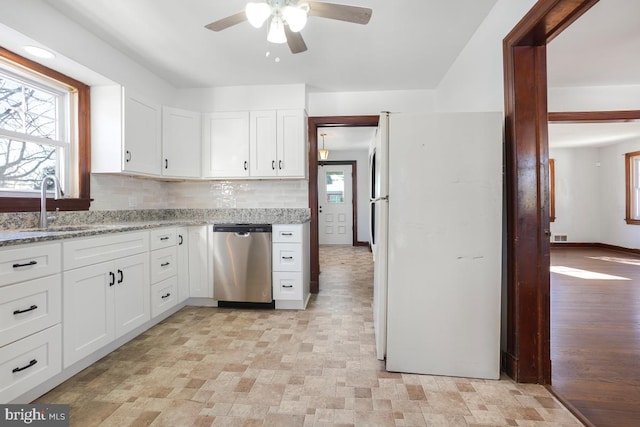 kitchen featuring white cabinets, dishwasher, white refrigerator, tasteful backsplash, and light stone counters