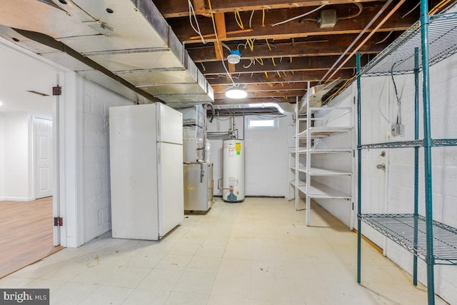 basement with gas water heater and white fridge