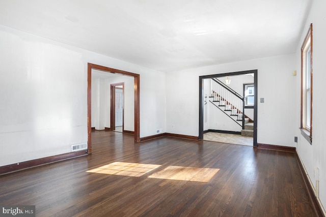 unfurnished room with dark wood-type flooring