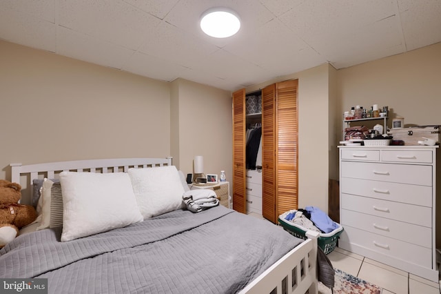 tiled bedroom featuring a closet