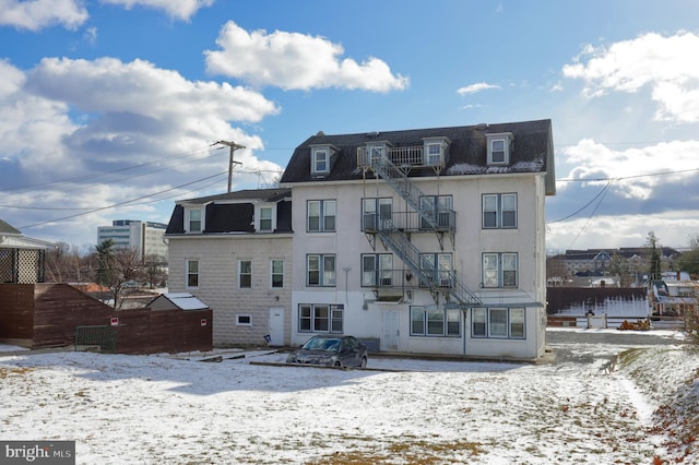 view of snow covered rear of property