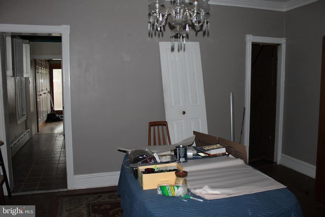 dining space with a baseboard heating unit and ornamental molding