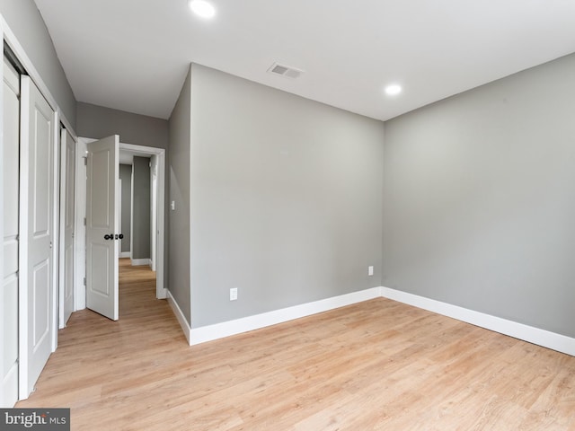 empty room with light hardwood / wood-style flooring