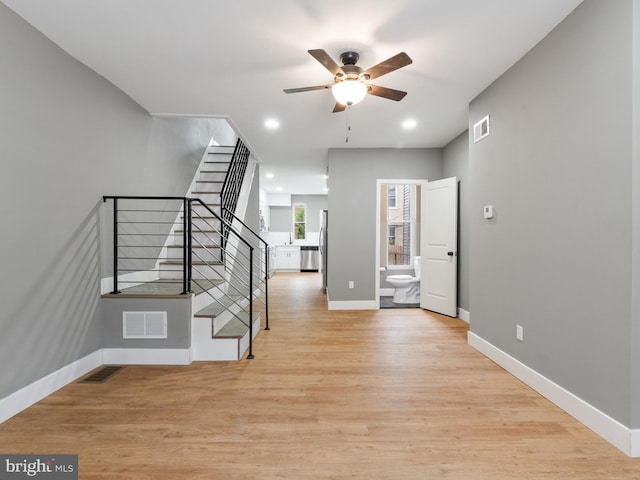 entrance foyer with ceiling fan and light hardwood / wood-style floors