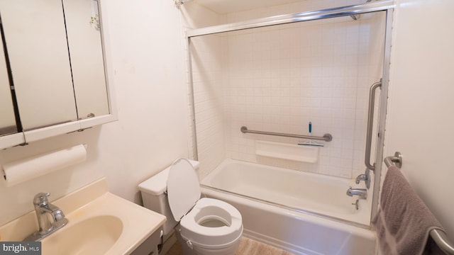 full bathroom featuring vanity, tiled shower / bath combo, and toilet