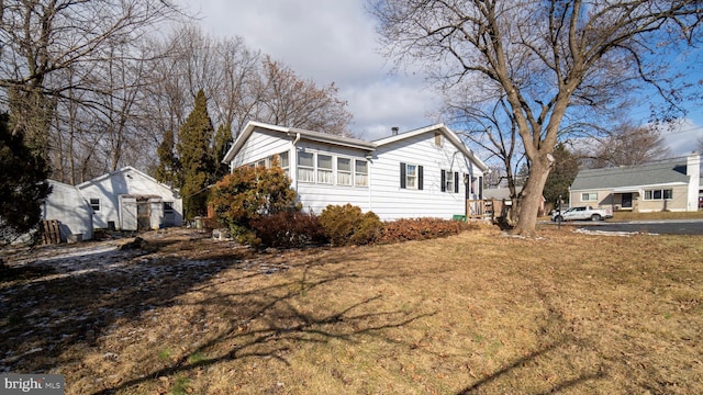 view of side of home featuring a lawn