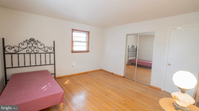 bedroom featuring hardwood / wood-style floors and a closet