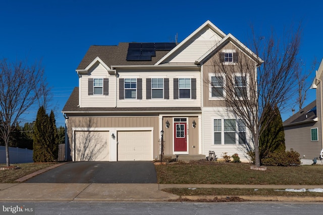 view of front of house with a garage and solar panels