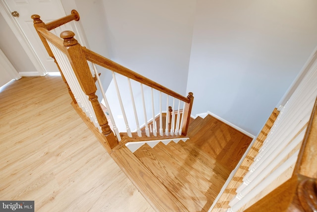 stairway with hardwood / wood-style flooring