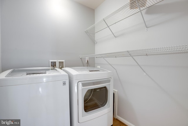 clothes washing area featuring washer and clothes dryer