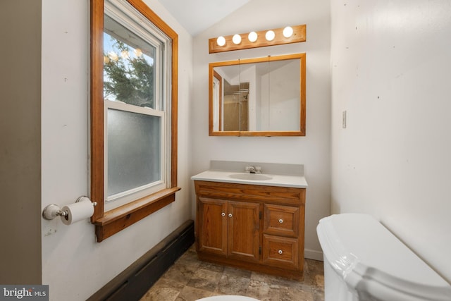 bathroom with vanity, toilet, and lofted ceiling