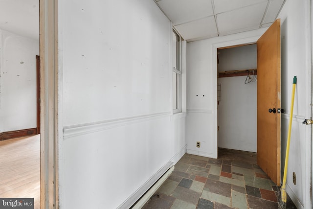 hallway featuring a paneled ceiling