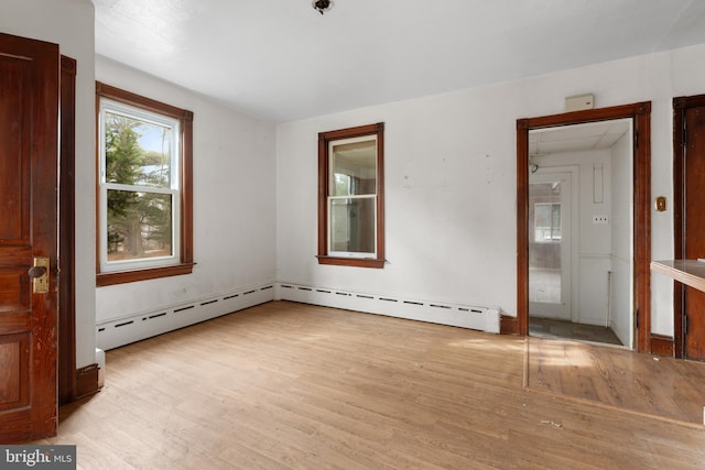 unfurnished bedroom featuring light hardwood / wood-style floors and a baseboard radiator