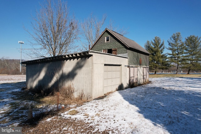 snow covered property with a garage