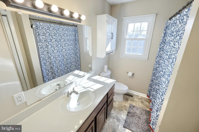 bathroom featuring vanity, walk in shower, and toilet