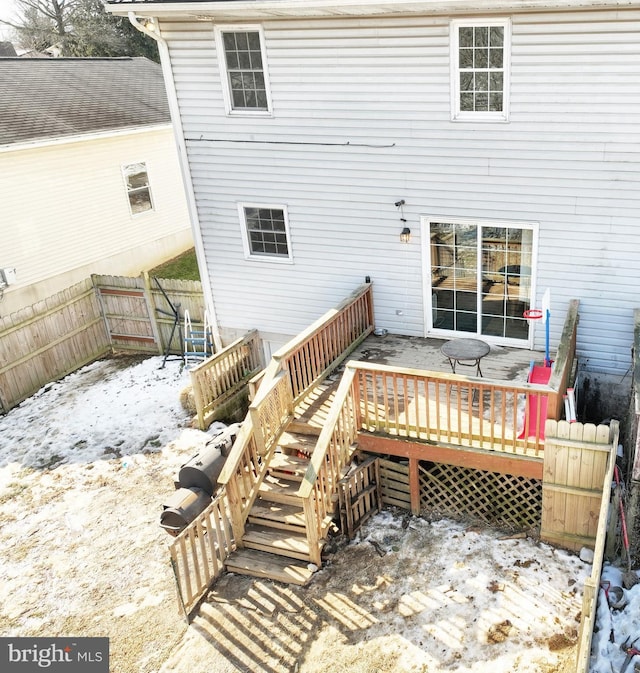 snow covered property with a deck