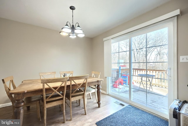 dining area with a notable chandelier and wood-type flooring