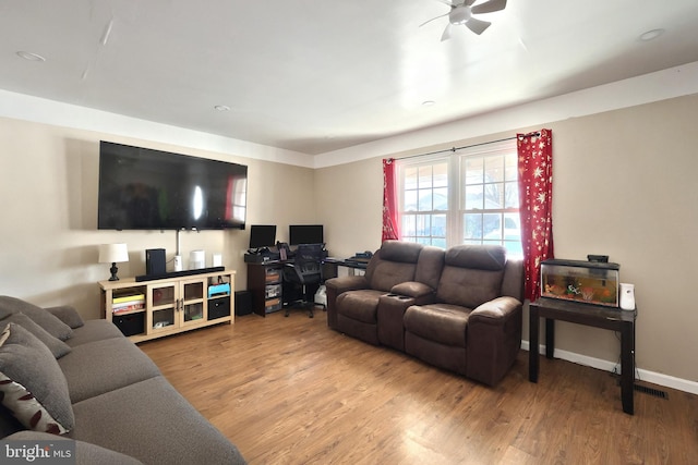 living room with hardwood / wood-style flooring and ceiling fan