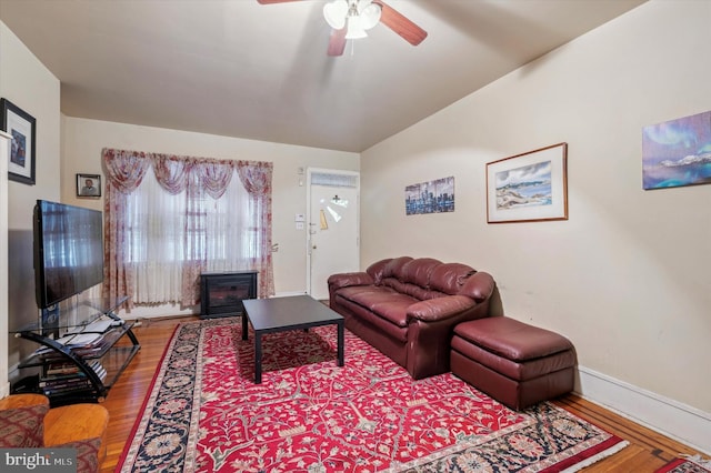 living room featuring ceiling fan and wood-type flooring